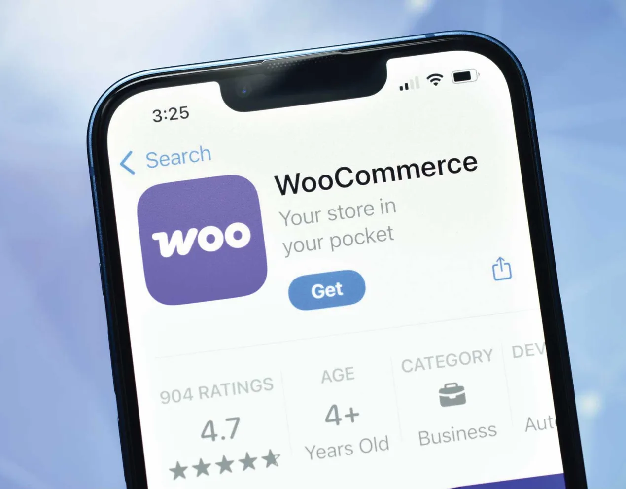 A phone showing the WooCommerce app listing in the App Store