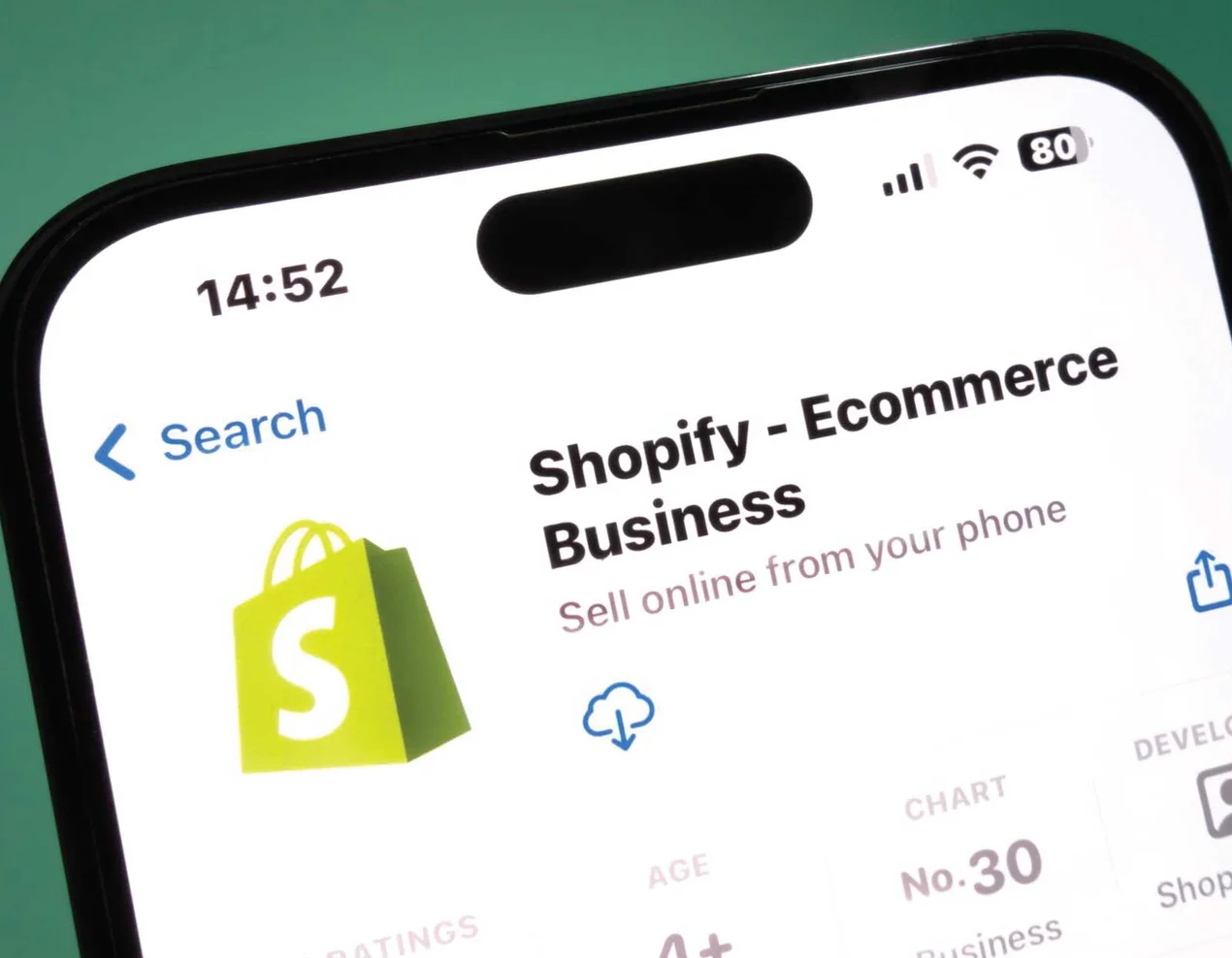 An iPhone displaying the Shopify — Ecommerce Business app listing on the App Store